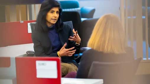 Chancellor Ramchand speaking with a colleague